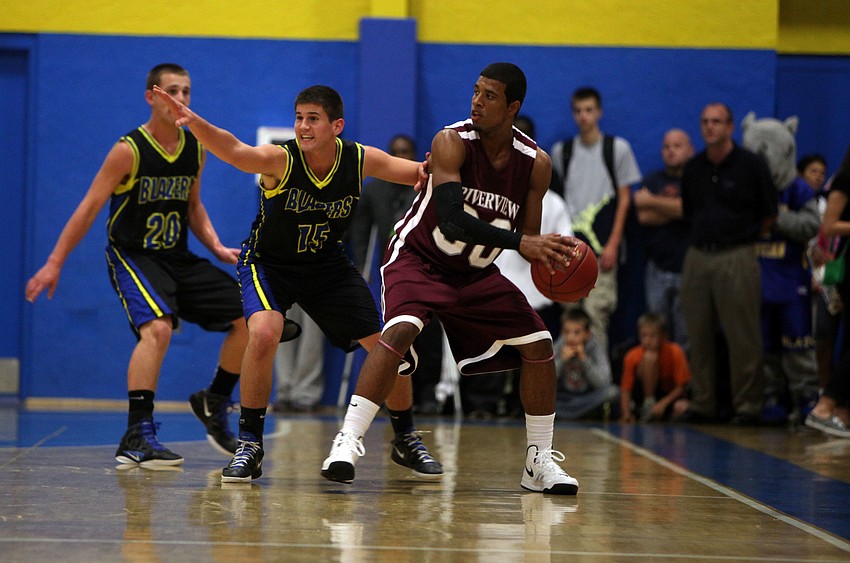 Sarasota Christianâ€™s Lance Helmuth, No. 44, and Joshua Yoder, No. 15, try to prevent Riverviewâ€™s Austin Walker, No. 30, from passing the ball.
