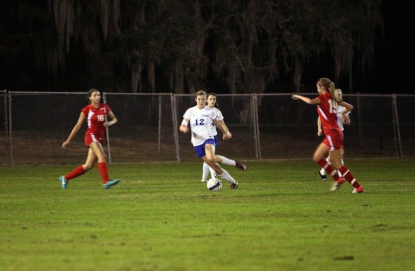 Sarasota Christianâ€™s Kelsey Murphy, No. 12, runs with the ball.