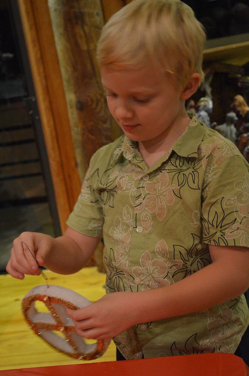Halden Parker chooses a Christmas ornament.