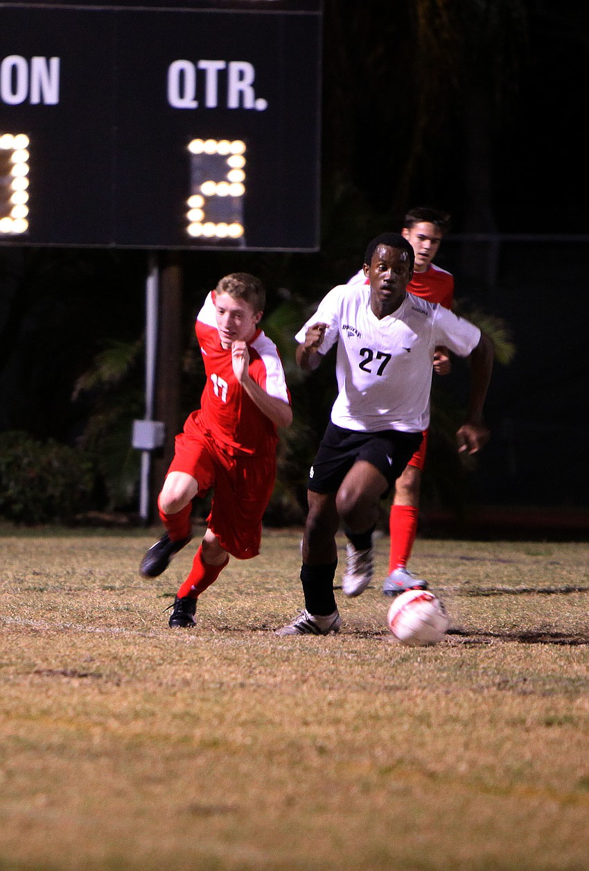 Bookerâ€™s Solomon LaBone Etienne, No. 27, makes his way up the field with the ball while Cardinal Mooneyâ€™s Blake Young, 17, tries to catch up to him.
