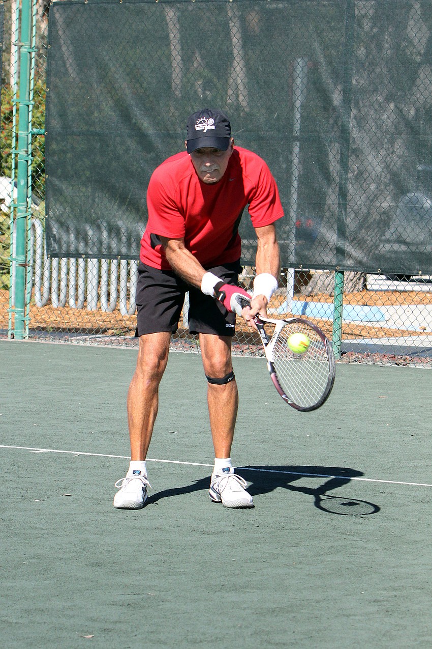 Scott Hase goes for a low backhand Friday, Dec. 7, at the Longboat Key Public Tennis Center.
