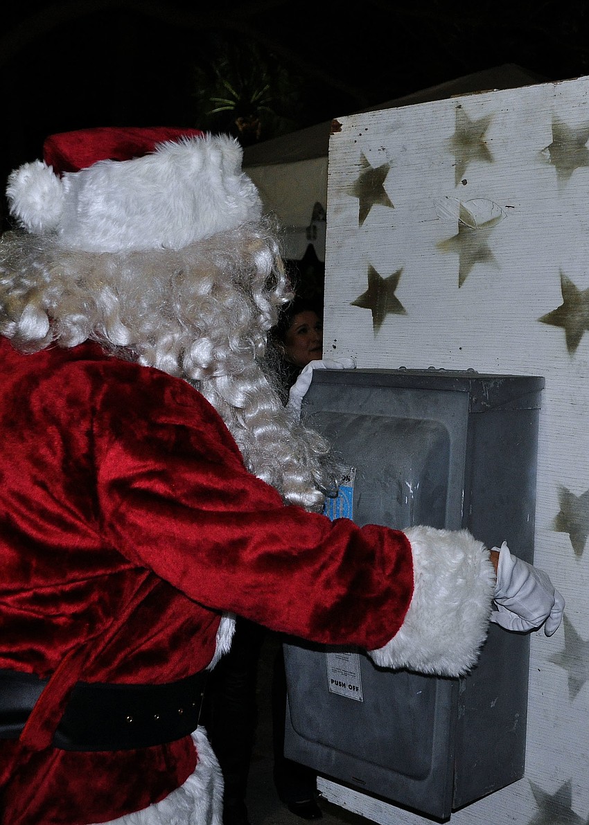 Santa flips the switch to turn on the St. Armands Christmas tree Friday, Dec. 7, during the Holiday Night of Lights on St. Armands Circle.