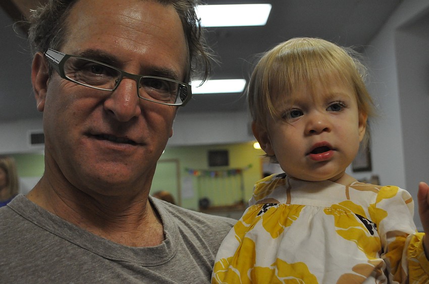 Jonathan Yunis holds his 1 year-old daughter Jillian.
