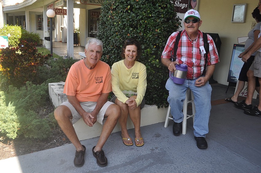Bob and Patfeso and Mike van Dyke listen to Larry Stokes sing and play the guitar.