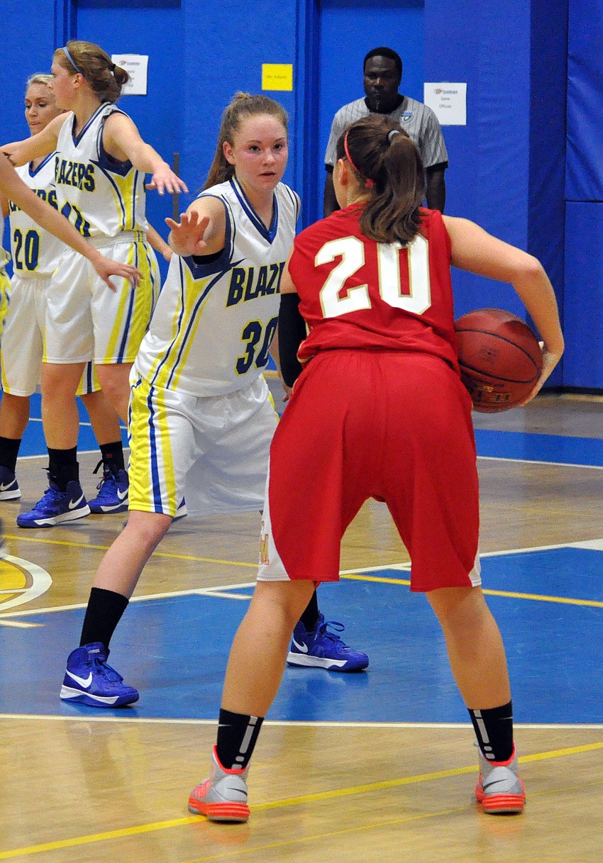 Sarasota Christianâ€™s Heidi Miller, No. 30, tries to block Cardinal Mooneyâ€™s Bridget Walsh, No. 20, from passing the ball.