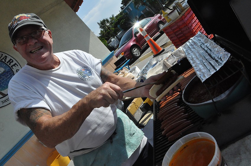 James Johnson a.k.a Fishman makes hotdogs for customers.