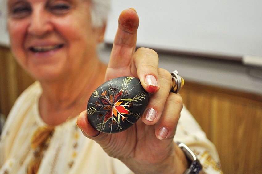 Tetiana Silecky with the final product of her demonstration on how to make traditional Pysankas, â€œwritten eggs,â€ at the Gulf Gate Library.