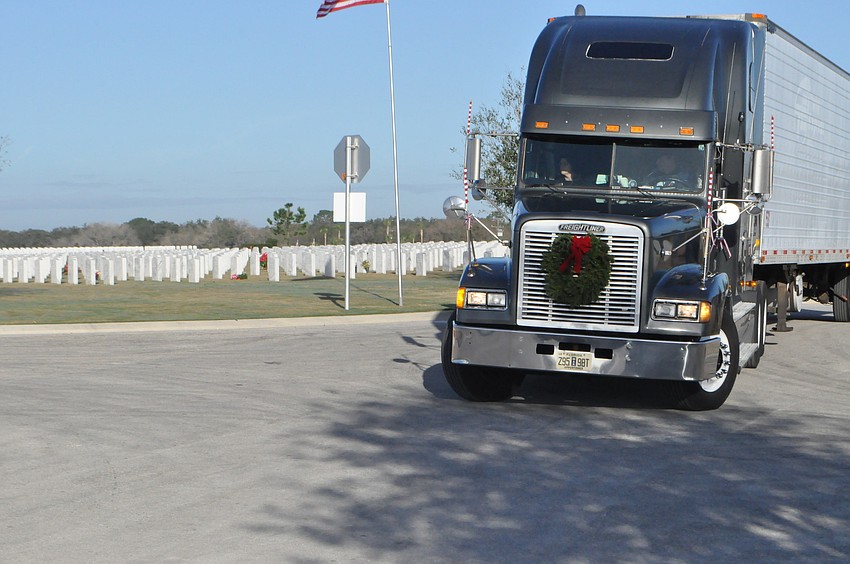 A semi truck filled with over 5,000 wreaths pulls into the Sarasota National Cemetery.