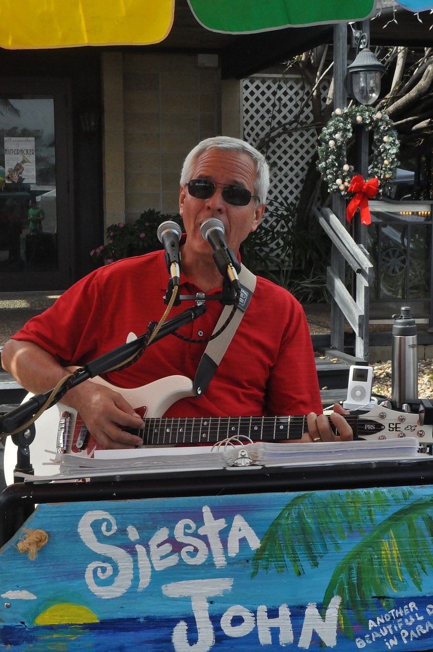 John Sollazzo sings tunes at the Siesta Key Farmers Market.