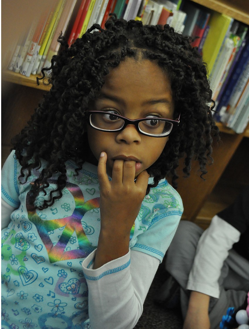 Zekiah Slaughtr intently listens to the story.