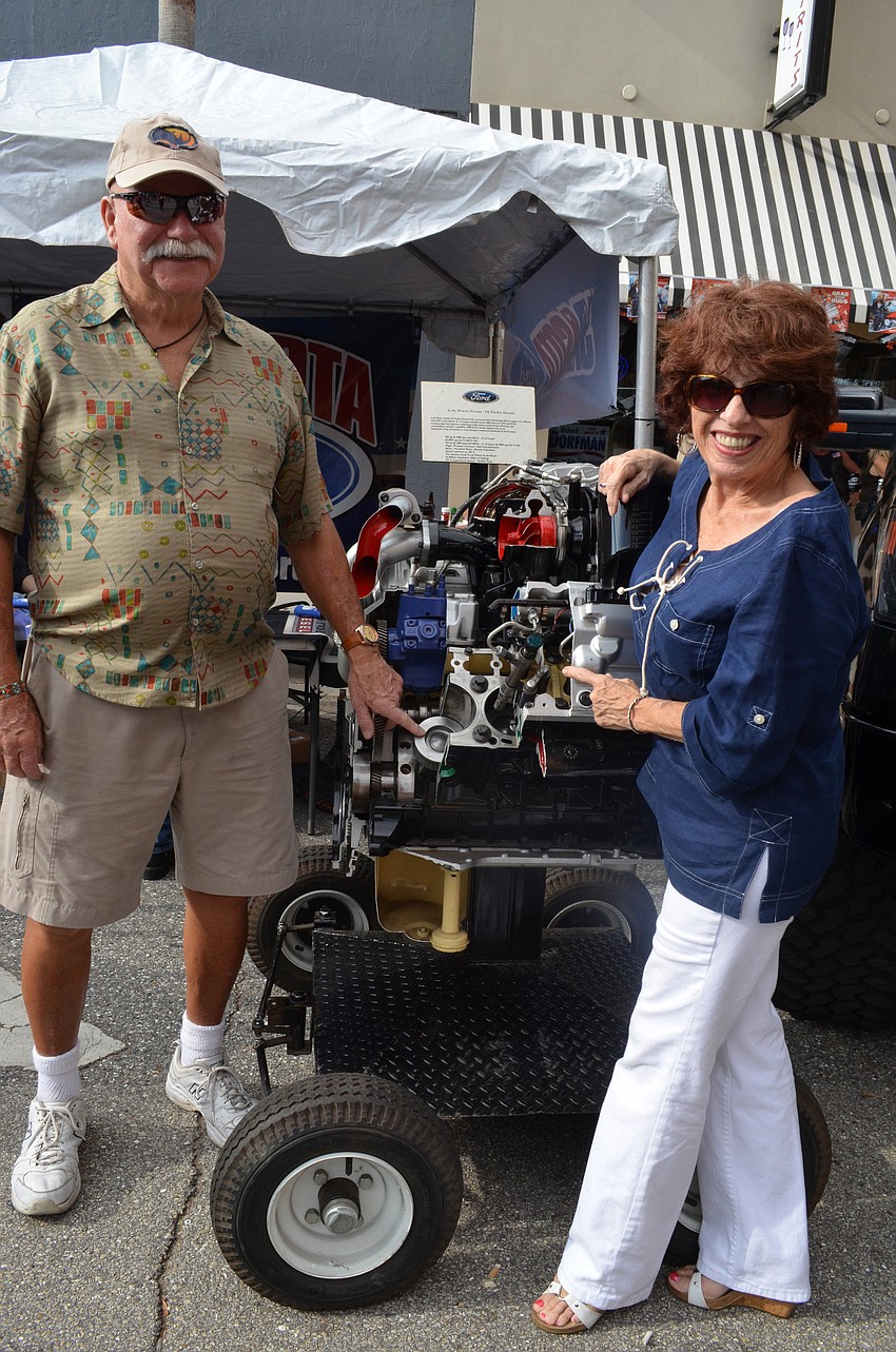Rick Oliver and Beth Segreti check out a Ford engine.