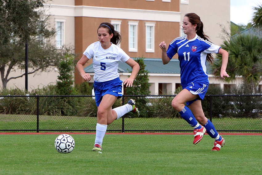 Sarasota Christianâ€™s Brittany Swart, No. 5, and Northside Christianâ€™s Kayla Church, No. 11, hustle to get to the ball.