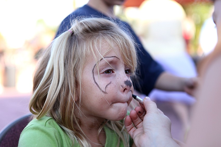 Kaylin Smith, 5, has her face done up like a puppy dog Friday, Sept. 28 during the pet blessing ceremony at Our Lady of Mount Carmel in Osprey.