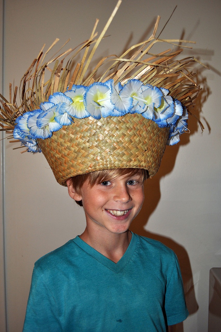 Spencer Ballard, 9, wears a festive straw hat at the luau.