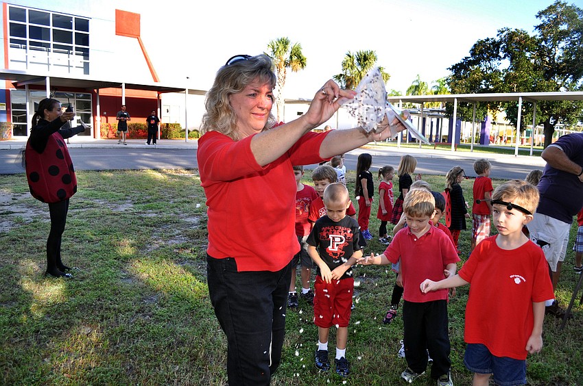 Kindergarten teacher Debbie Lacy releases the live ladybugs during the Lady Bug Drill Thursday, Oct. 4, at Gulf Gate Elementary.