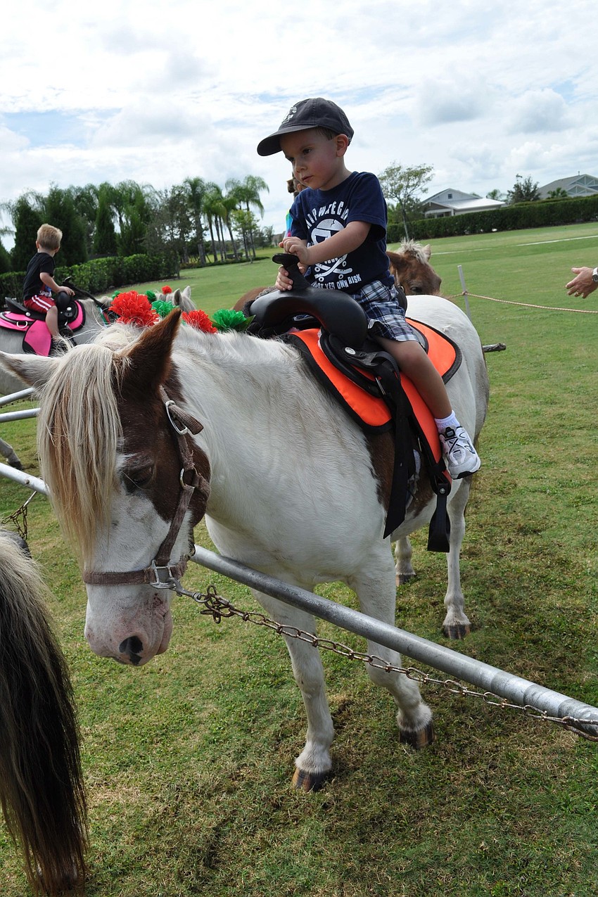 Andrew Fertig, 3, was all smiles during his first on a pony.