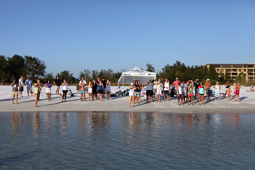 Friends, family and supports watch from shore as Brad Ward takes off for the first hour of paddling.