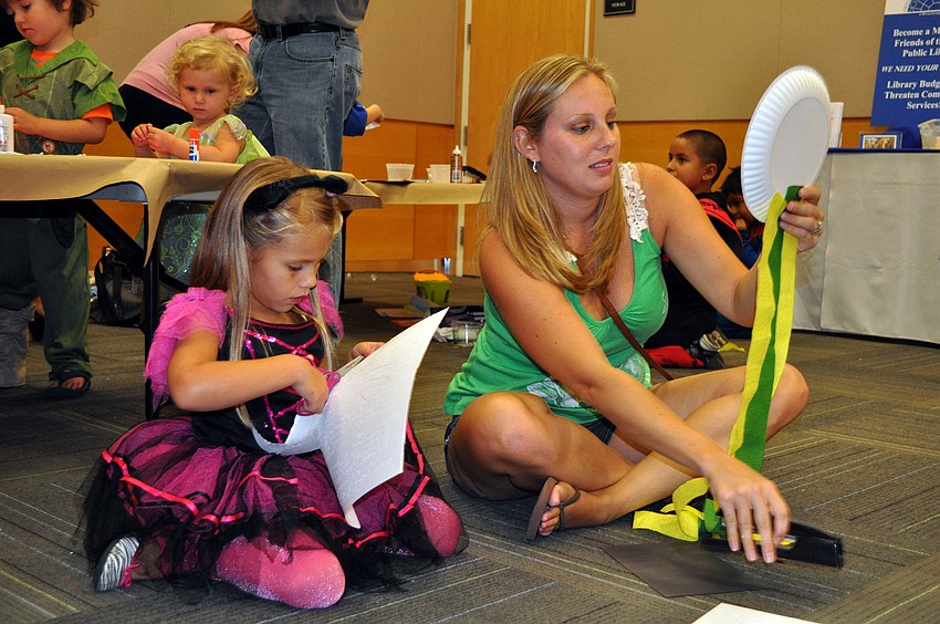 Kirsten, 5, and her mother, Nicole, Soler work on making a ghost.