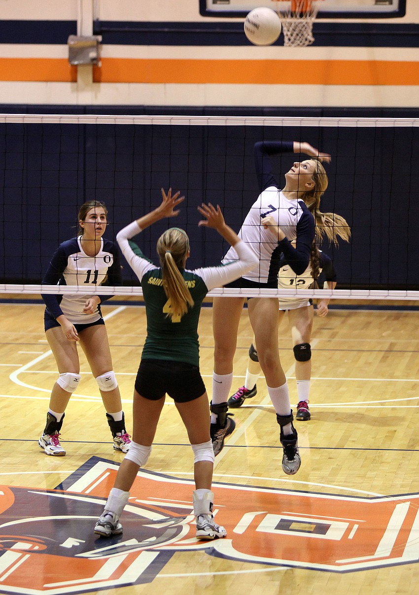 Emily Greenwood, No. 7, prepares to hit the ball while Gabrielle Woodruff, No. 4, gets in position to block.