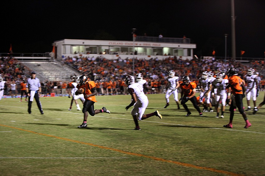 Rod Tullis, No. 7, makes his way down the field with the ball.