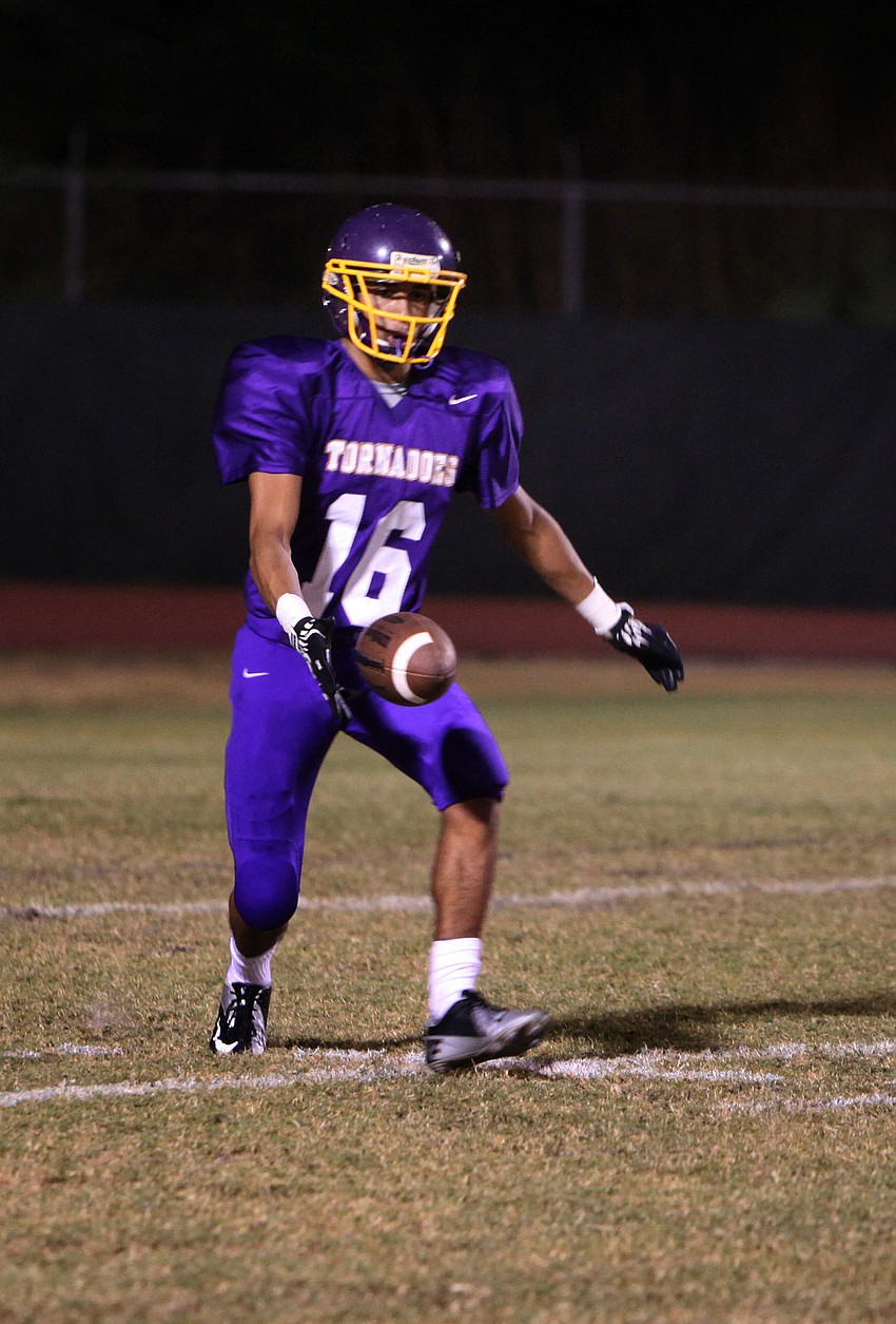 Dominik Deramo, No. 16, prepares to punt the ball.