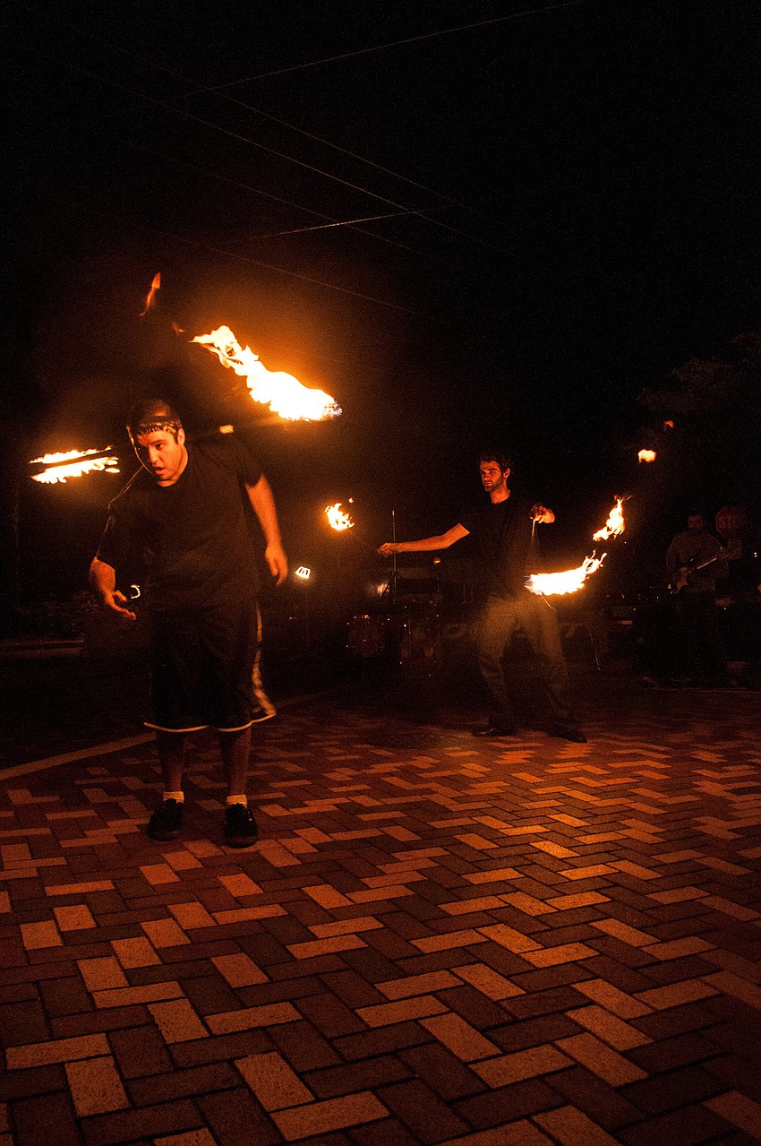 Richard â€œRich Rageâ€ Dean and Mitchell â€œMythmakerâ€ Englander of Urban Spiral Dream Company perform for a crowd.