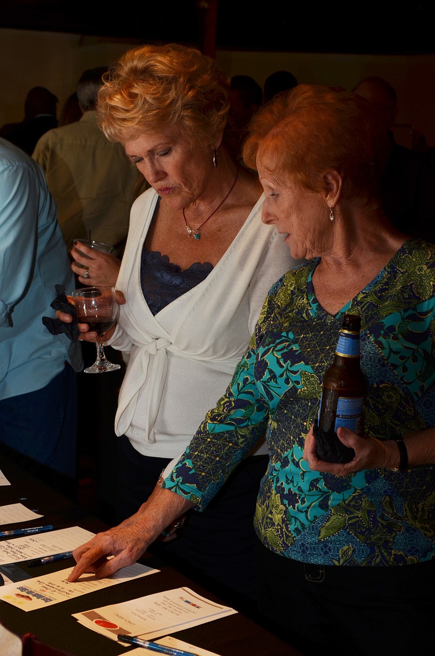 Doris Sabbatini and Mary Printz check out the silent auction