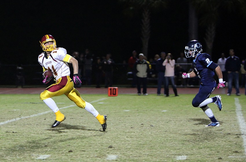 Casey Gunderson, No. 11, runs towards the in zone as The Out-of-Door Academyâ€™s Brandon Place, No. 2, tries to catch him.