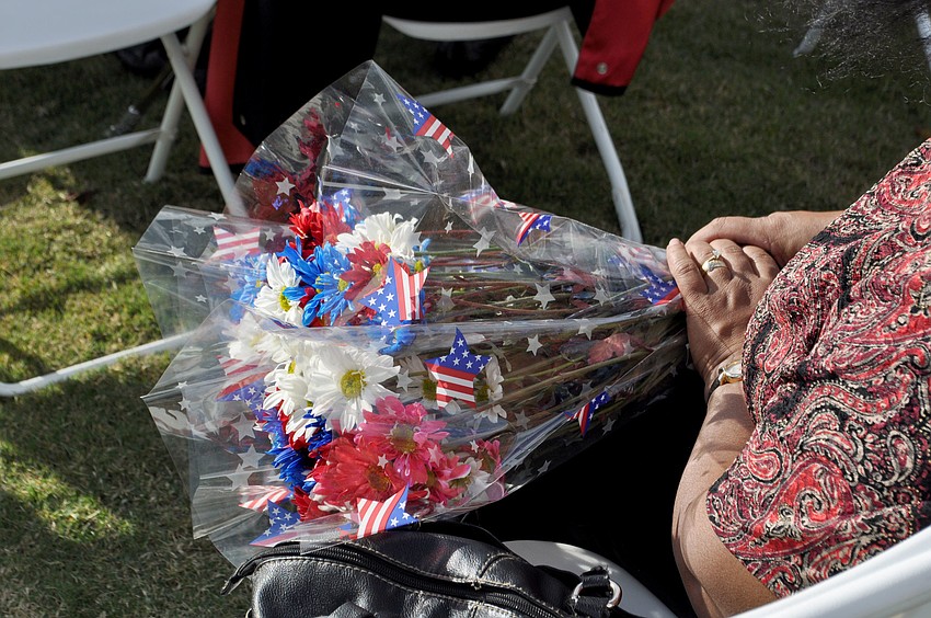 An attendee holds flowers during mass.