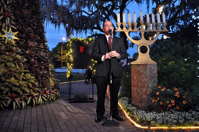Marty Haberer talks to the crowd Tuesday, Dec. 4, at the annual lighting of the bromeliad tree at Marie Selby Botanical Gardens.