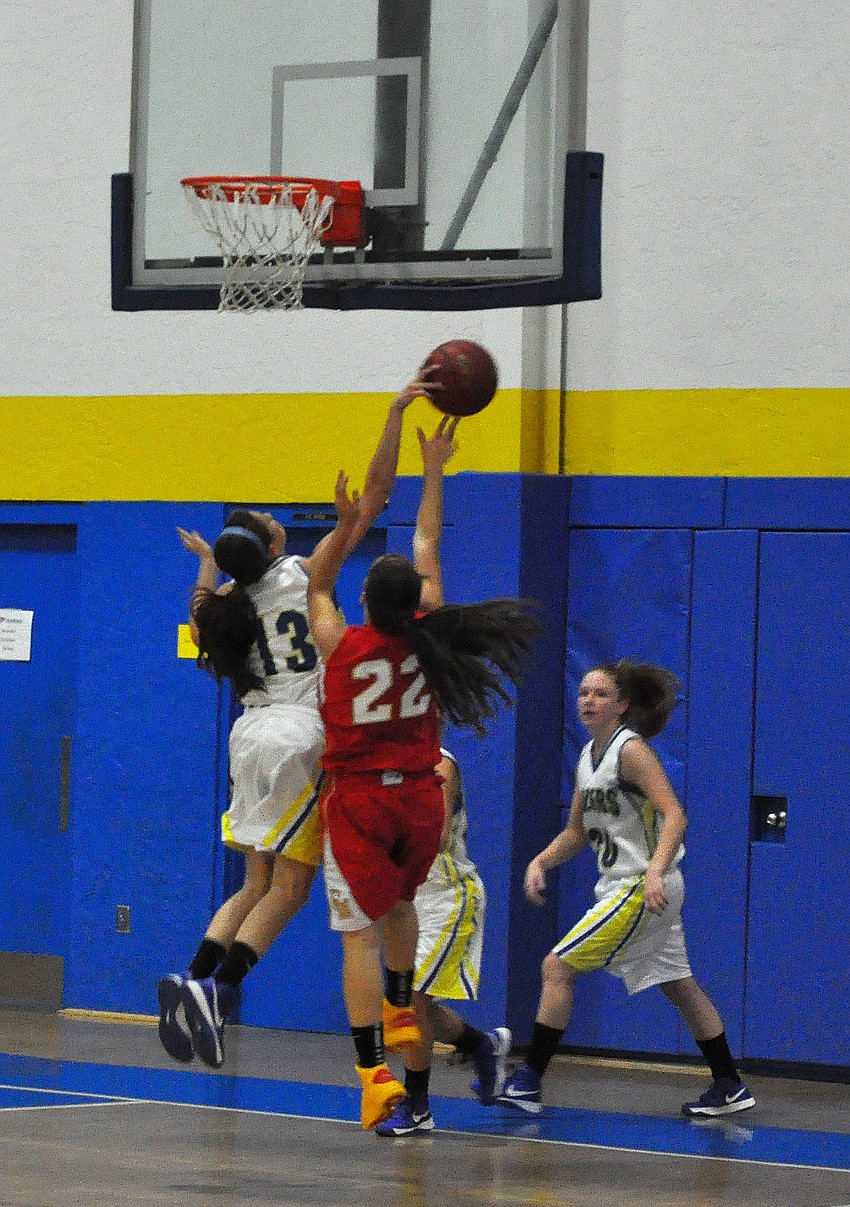 Cardinal Mooneyâ€™s Camille Giardina, No. 22, goes to shoot a lay up while Sarasota Christianâ€™s Nicole Wittimer, No. 13, attempts to stop her from scoring.