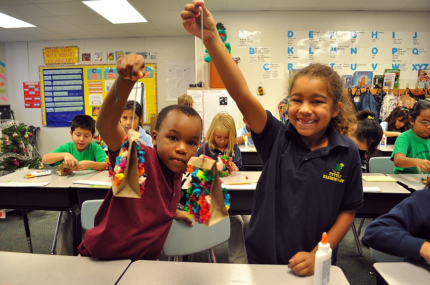 Mrs. Karon Berkeyâ€™s students Sheldon Richardson and Angelina Cabriales show off their finished piÃ±atas. Mrs. Berkeyâ€™s class was learning about how Christmas is celebrated in Mexico.