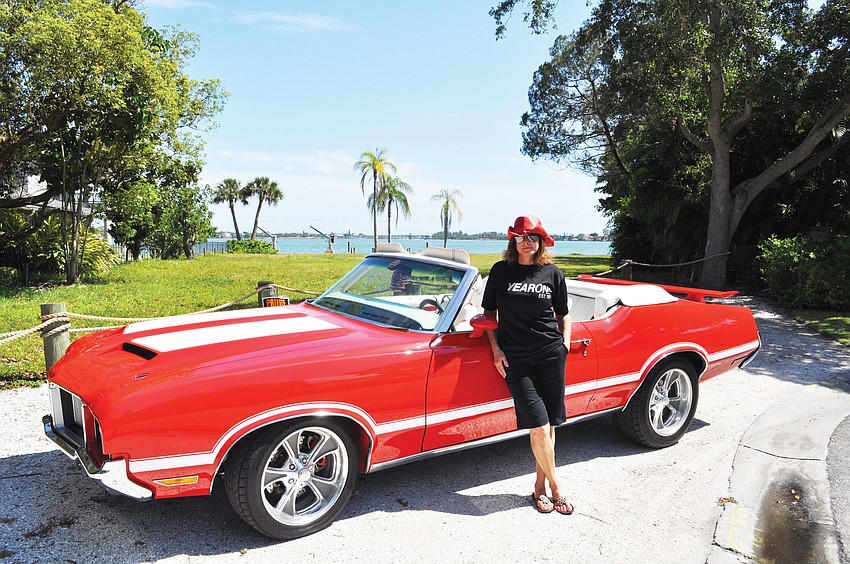 Debora Blomster poses in front of her decked-out 1972 Cutlass Supreme she dubbed â€œPenelopeâ€. Blomster and some of her friends took part in the Gumball Rally from New York to Los Angeles this year.
