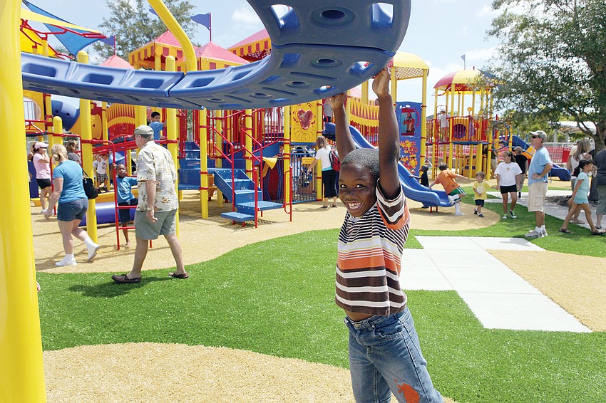 Shawn Mitchell, 8, spun around on one of the many new pieces of playground equipment at the new circus-themed playground at Payne Park