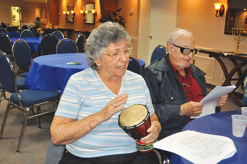 Renee Gold plays one of the many drums and sings along with her husband, Bert, at Temple Emanu-Elâ€™s La La La Havdalah event.