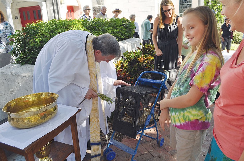 Ellie Fitzgerald brought her hen, Roxy, to be blessed at Church of the Redeemer's Blessing of the Animals.