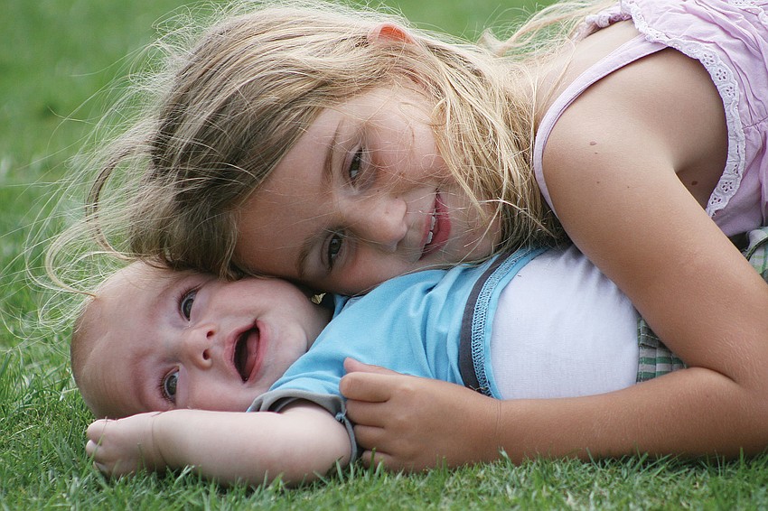 Sirelle Standor cuddled with baby brother Moa, 7 months, during Bayside Community Churchâ€™s Easter Eggolution March 31. Published April 5, 2012.