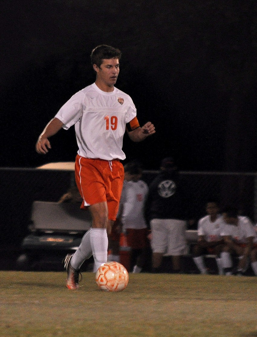 Sarasota High Schoolâ€™s Ian Grubb, No. 19, dribbles the ball down the field.