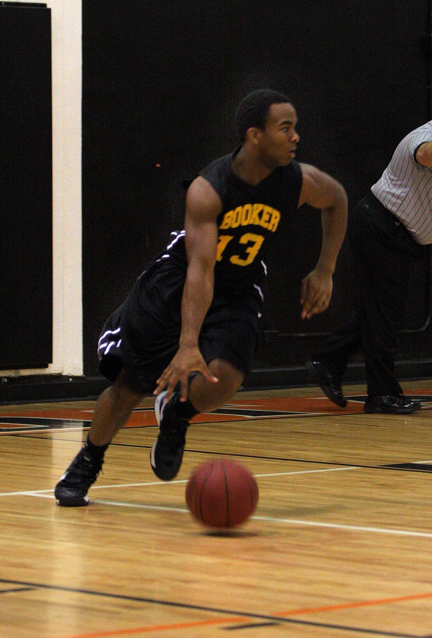 Booker High Schoolâ€™s Huletty-Netter Truth, No. 13, dribbles the ball down the court.