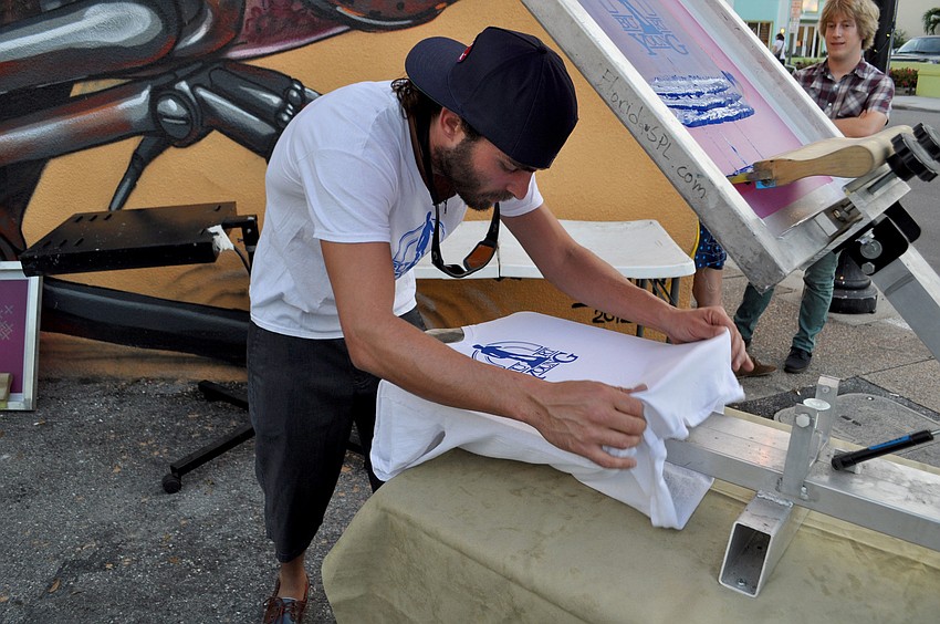 Joe Lombardi screen-prints a shirt for the event.