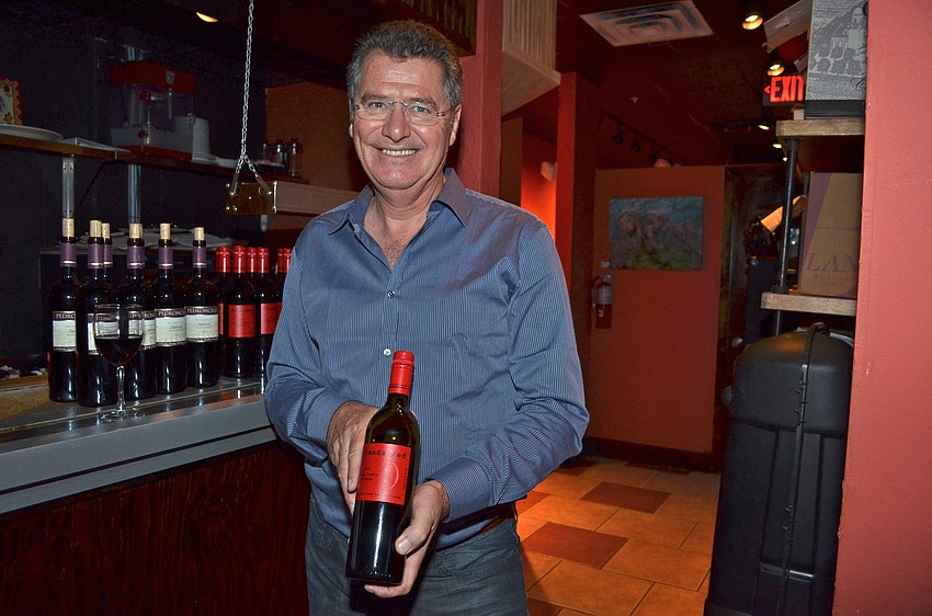 Robin Stephenson with Premier Beverage holds a bottle of Pedroncelli.