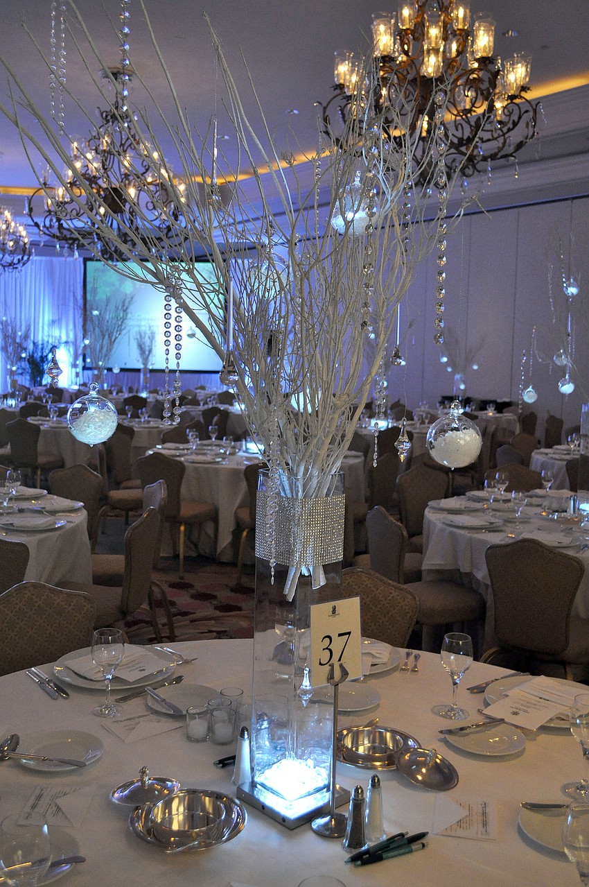 The each table inside the ballroom had very ornate centerpieces with globes filled with fake snow and icicles and lots of white, sparkly branches.