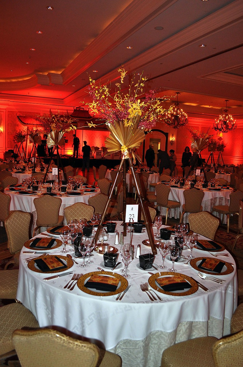 Each table had a beautiful centerpiece made from bamboo and orchids designed by Elegant Designs Floral Art Studio.