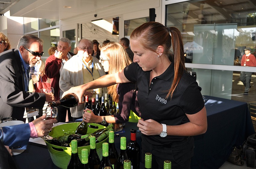 Jill Whitman pouring wine.