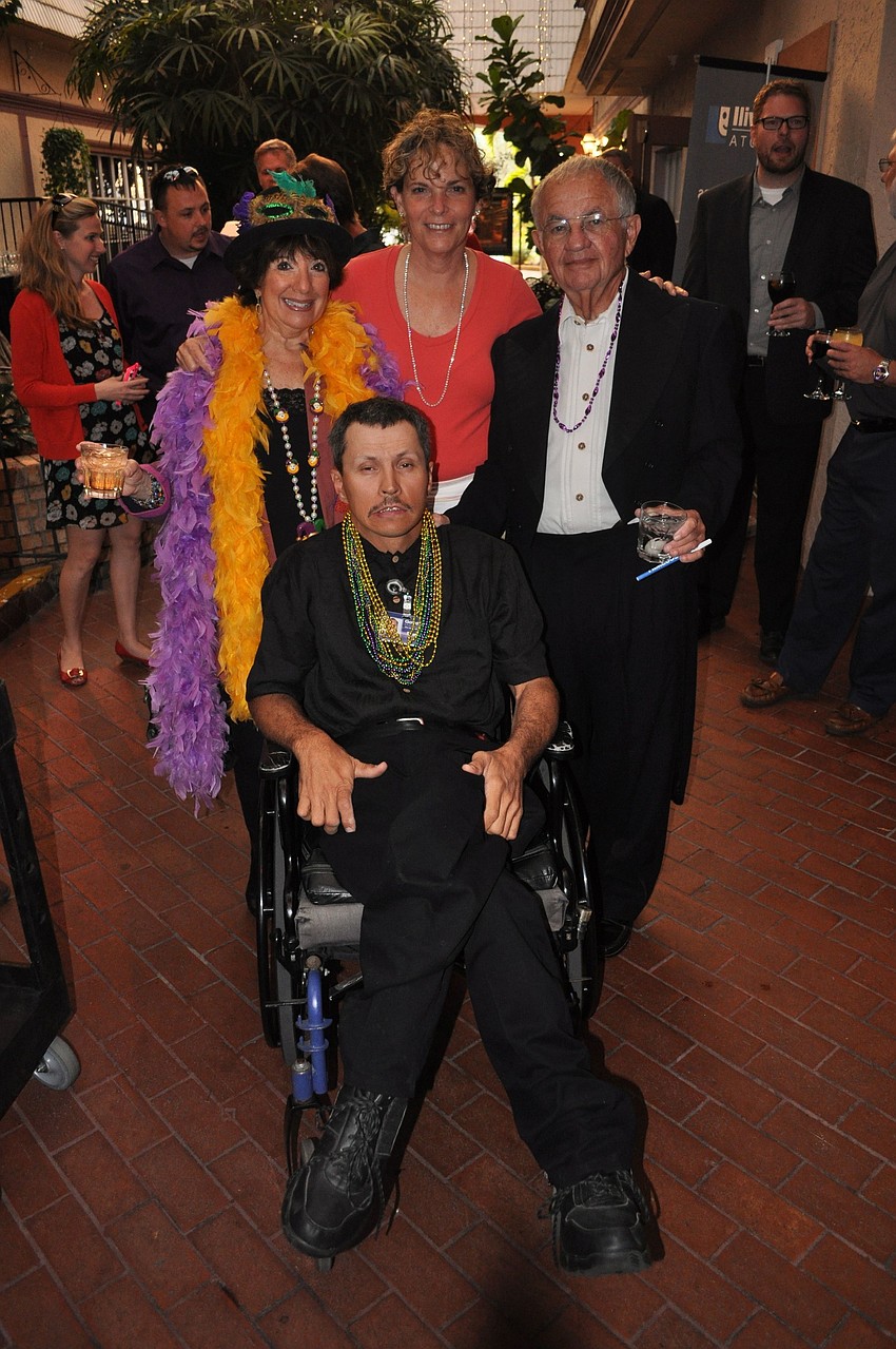Barbara Baseman, Charlie Lenger and Stephen Baseman surround Doug Ott, Goodwillâ€™s Employee of the Year