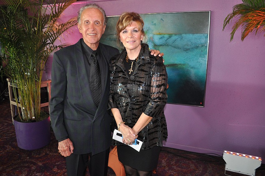 Darrell and Lesley Huntley pose in front of the painting they donated.
