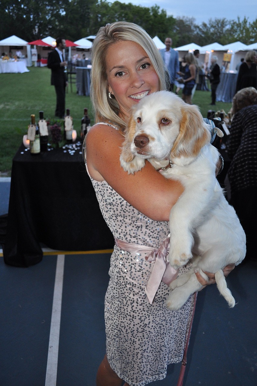 Denise Aberle holds May, a Dakota sport retriever, who was up for auction at the Banyan Bash.