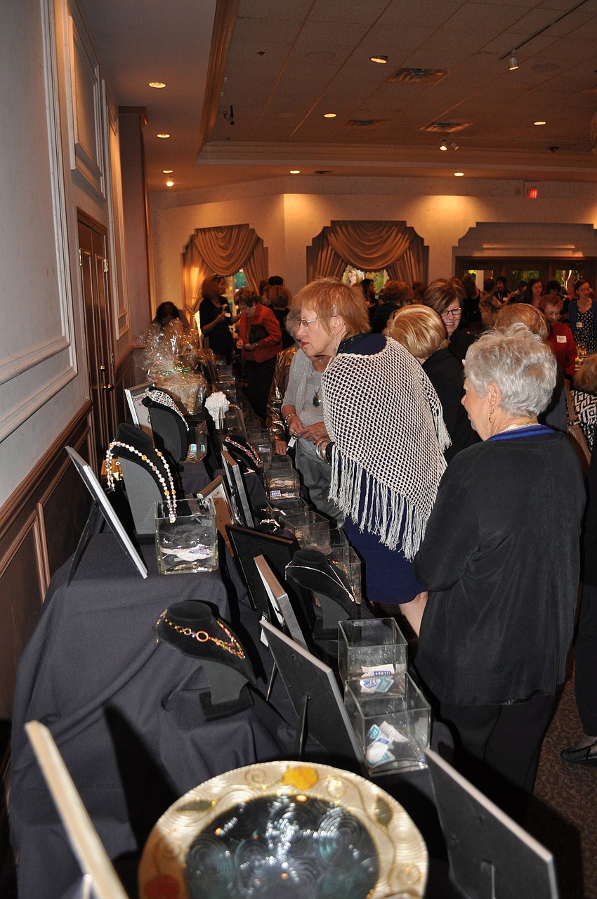 Women look at the items up for bid at the silent auction.