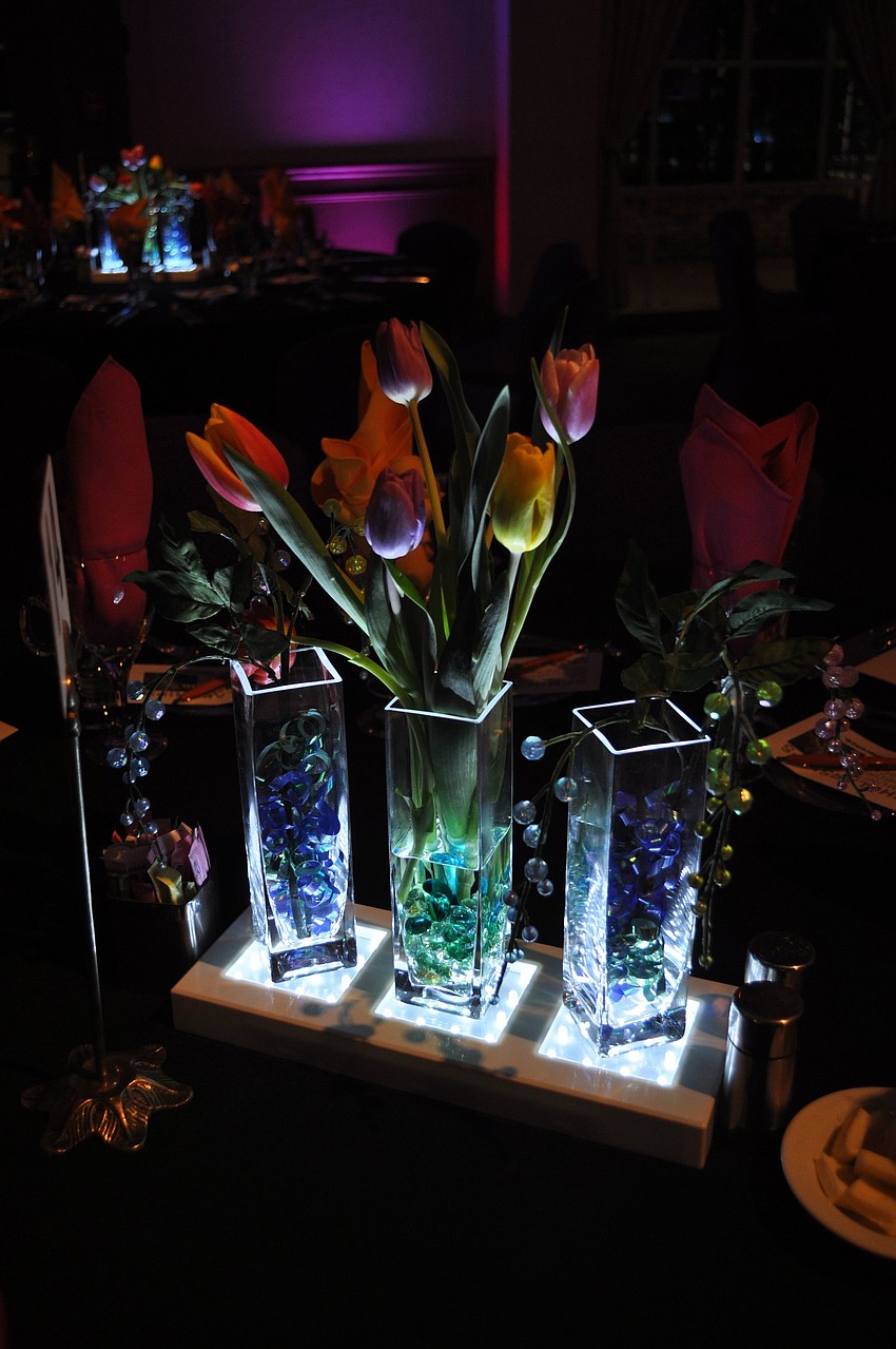Purple, pink and yellow tulips looked beautiful in lit up glass vases.