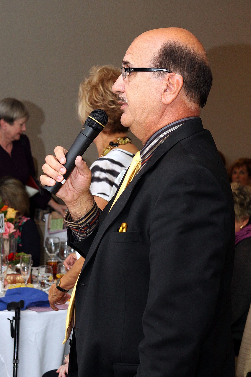 Tony Liga asks Mr. Hill a question during the luncheon.